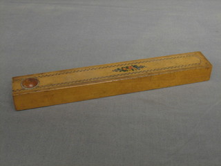 A wooden needle case containing a collection of various ivory sewing implements