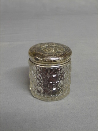 A circular cut glass dressing table jar with embossed silver lid decorated angels 3" (lid jammed)