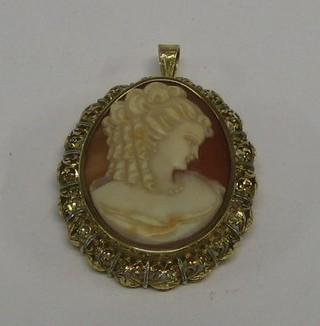 A shell carved cameo brooch in the form of a lady, contained in a gilt metal mount