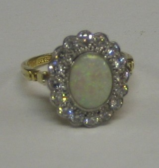 A lady's 18ct gold dress ring set an oval cut opal surrounded by 16 diamonds (approx 0.70ct)