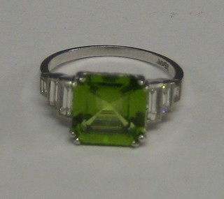 A lady's 18ct white gold dress ring set a square cut peridot and 6 baguette cut diamonds (approx 0.50ct)