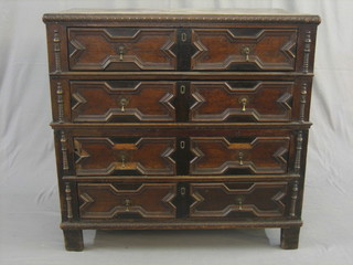 A Continental Jacobean oak chest of 4 long drawers with carved tear drop handles, raised on bracket feet 37"