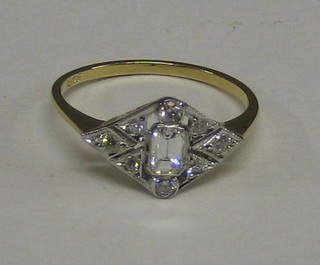A lady's 18ct yellow gold diamond shaped dress ring set a square cut diamond supported by 4 circular diamonds and other small diamonds