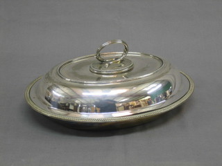 An oval silver plated entree dish and cover