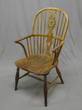 A 19th/20th Century elm and yew carver chair with solid elm seat and H framed stretcher