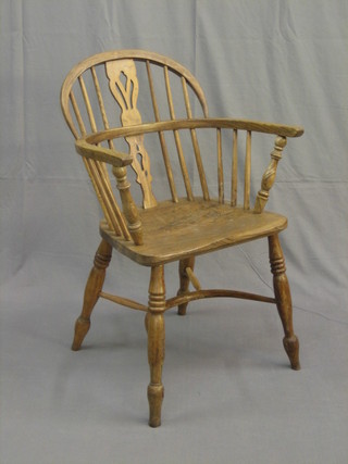 An 18th Century style elm comb back chair with crinoline stretcher and turned supports
