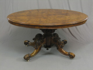 A Victorian figured walnut oval snap Loo table, raised on a carved column 54"
