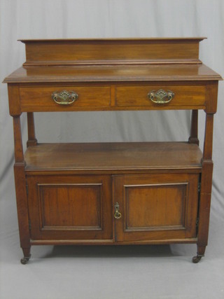 An Edwardian walnut buffet, the raised back fitted 2 drawers above a recess with cupboard beneath 41"