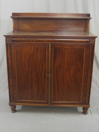 A Victorian mahogany chiffonier with raised shelved back, the interior fitted shelves enclosed by panelled doors, raised on turned supports 43"