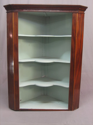 A Georgian mahogany hanging corner cabinet with moulded cornice, the interior fitted 3 shelves 42"