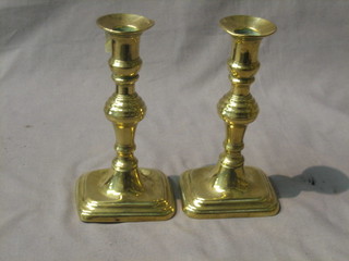 A pair of 19th Century brass candlesticks raised on rectangular feet 7"