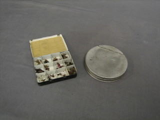 A small box of flies 4" and a circular metal line box 4"