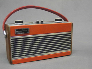A Roberts portable radio contained in a red teak case