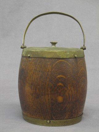 A turned oak biscuit barrel with silver plated mounts