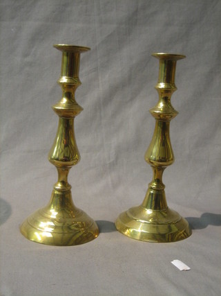 A pair of 19th Century brass candlesticks with ejectors