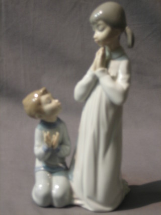 A Lladro figure of praying girl and kneeling boy, base marked 4779, 9"