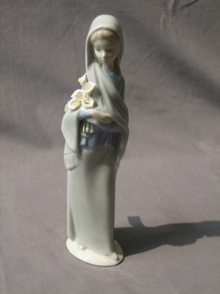 A Lladro figure of a standing girl with bunch of lilys 9"