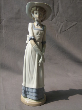 A Nao figure of a standing bonnetted lady 12"