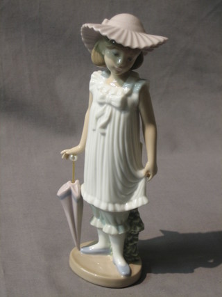 A Nao figure of a standing bonnetted girl with parasol 8"