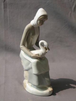 A Casades figure of a seated lady with bird 9"