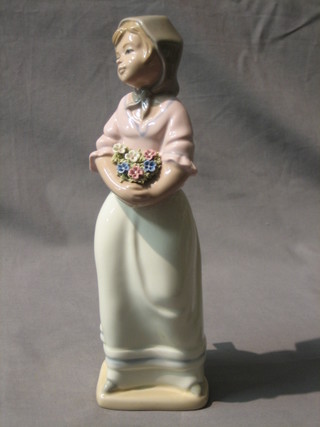 A Torralba figure of a standing girl with posy of flowers 10"