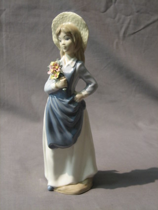 A Mediflor figure of a standing bonnetted girl with flowers 10 1/2" 