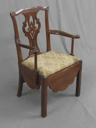 A 19th Century Chippendale splat back commode chair with upholstered drop in seat, raised on square supports