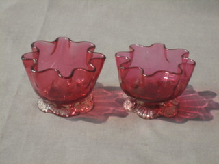 A pair of circular Cranberry salts with clear glass petal bases 2 1/2" 