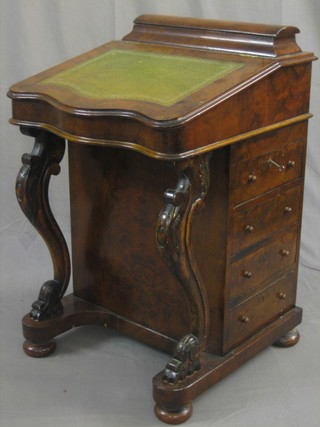 A Victorian figured walnut Davenport of serpentine outline with stationery box to the top, having an inset tooled leather writing surface, the pedestal fitted 4 long drawers and raised on cabriole supports 21"