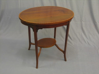 An Edwardian oval inlaid mahogany 2 tier occasional table raised on square supports 29 1/2"