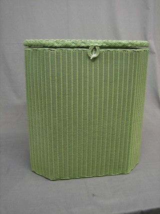 A green painted Lloyd Loom lozenge shaped linen basket with hinged lid 19"