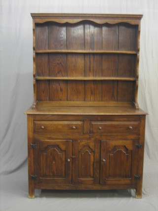 An oak dresser with raised back, the base fitted 2 drawers above a double cupboard 48"