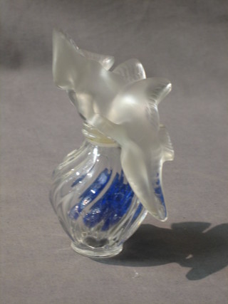 A Lalique scent bottle the stopper in the form of two diving doves, the base marked Nina Ricci Lalique bottle 4"