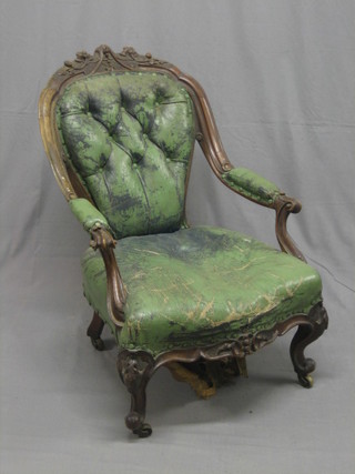 A Victorian carved walnut open arm chair with carved cresting rail with upholstered seat and back, raised on cabriole supports
