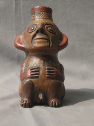 A South American Terracotta flask in the form of a seated naked man 8"