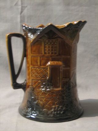 A pottery jug the base with musical box movement playing John Peel, 9"