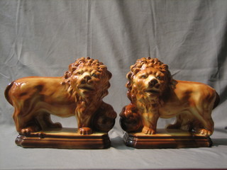 A pair of 19th Century treacle glazed Staffordshire figures of standing Medici lions with glass eyes (1 eye missing) 13"
