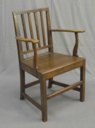An 18th Century elm open arm carver chair with solid seat and a similar standard chair
