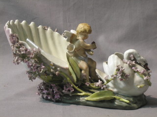 A 19th Century porcelain shell shaped table centre piece in the form of a cherub with shell 10"
