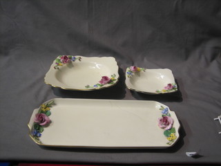 An 8 piece Royal Crown Staffordshire pottery dessert service with rose encrusted decoration comprising a pottery bowl, 6 matching bowls and a rectangular sandwich plate
