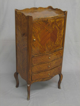 A 19th/20th Century French Kingwood cabinet of serpentine outline with three-quarter gallery enclosed by a panelled door, the base fitted 3 long drawers, raised on cabriole supports 17"