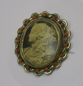 A Victorian pinch beck reversible mourning brooch set a hair sculpture to the reverse and portrait to the front