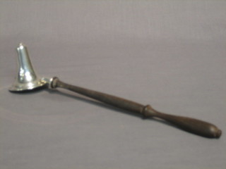 A modern silver candle snuffer with turned wooden handle