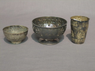 An Eastern embossed silver beaker 3" and a circular embossed Eastern silver bowl 4" and 1 other  2 1/2"