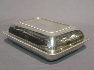 A rectangular silver plated twin handled entree dish and cover by Harrods