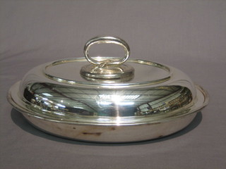 An oval silver plated entree dish and cover