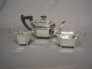 A Georgian style lozenge shaped 3 piece silver tea service comprising teapot, twin handled sugar bowl and cream jug, Birmingham 1938 33 ozs