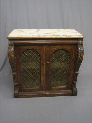 A Continental simulated rosewood chiffonier with faux marble top, fitted a secret drawer and cupboard enclosed by a pair of arch shaped grilled panelled doors and with carved Vitruvian scrolls to the sides 39"