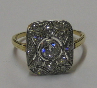A lady's 18ct yellow gold dress ring set a large diamond surrounded by numerous diamonds (approx 0.75ct)
