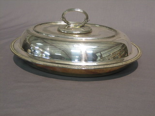 An oval silver plated entree dish and cover